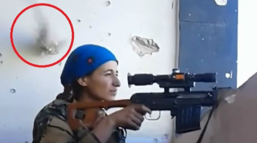 庫德族女戰士差點被ISIS武裝分子擊中頭部，敵方的子彈打中後方的牆壁。