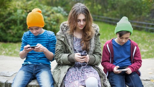 许多孩子与父母相处时，彼此都在使用手机。